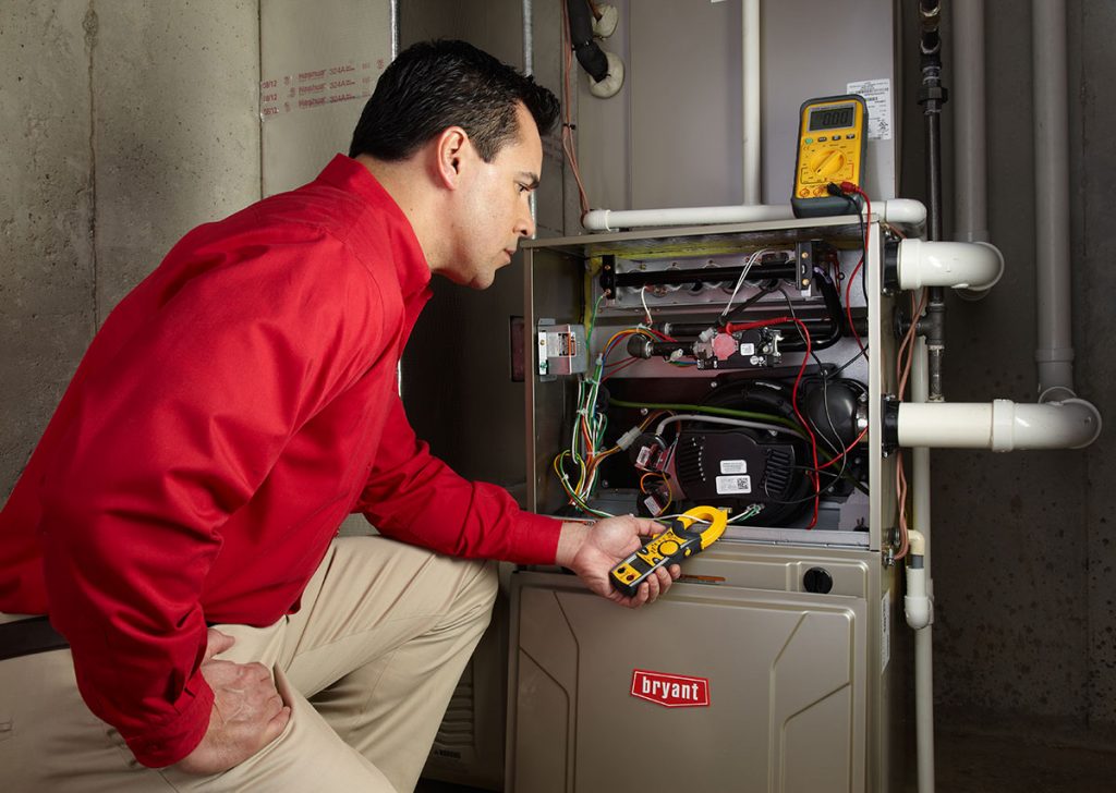 HVAC technician repairing an indoor furnace in Sun City West