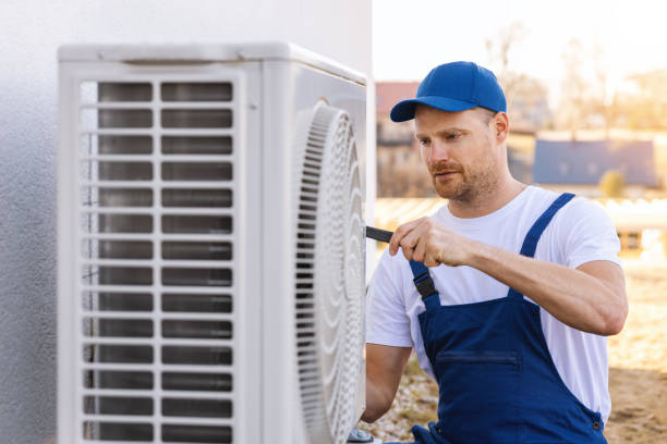 HVAC technician servicing an outdoor air conditioning unit in Sun City West