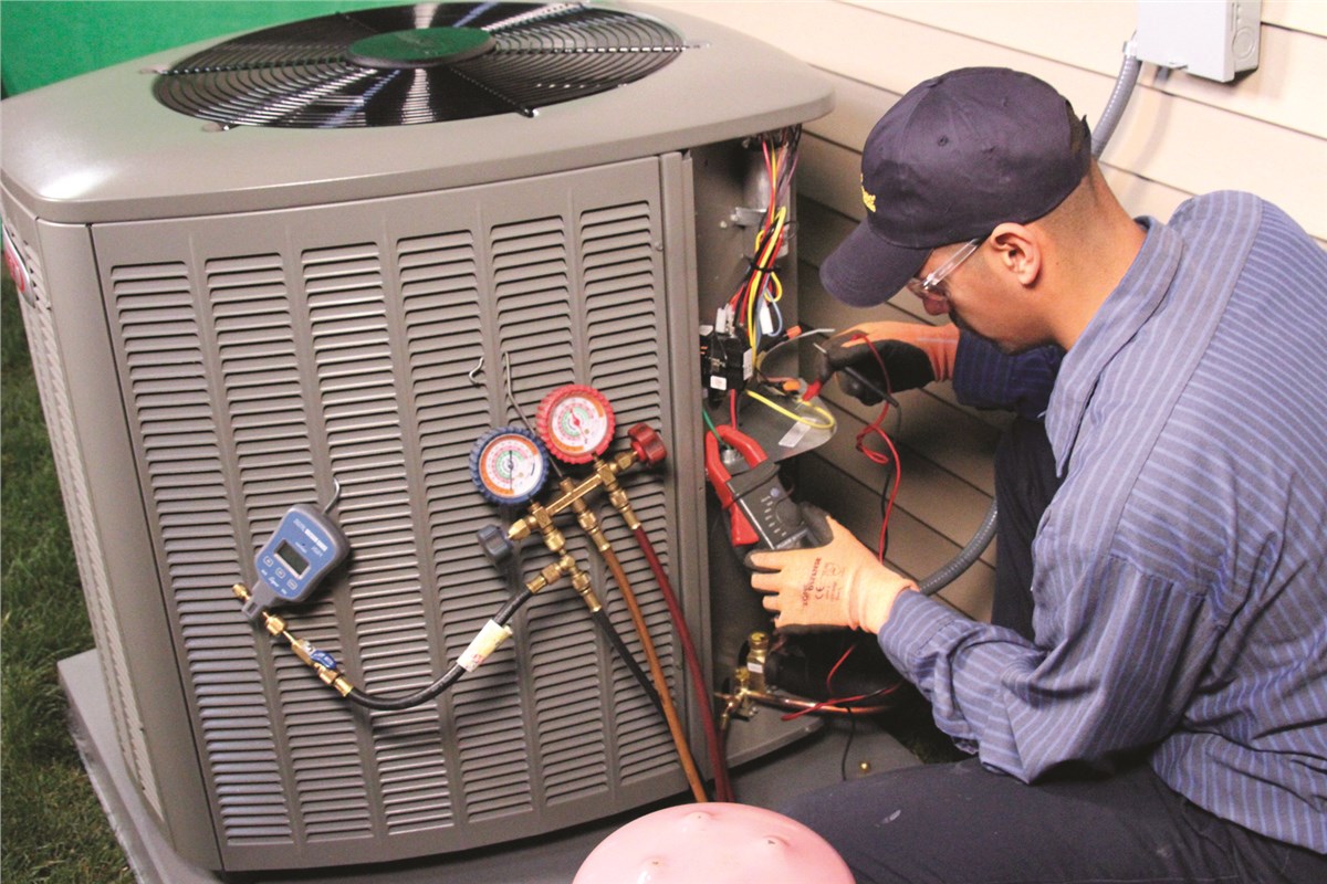 HVAC technician testing an outdoor air conditioning unit in Sun City West
