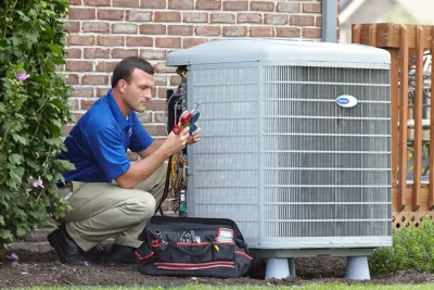 HVAC technician inspecting an outdoor air conditioning unit in Sun City West, AZ